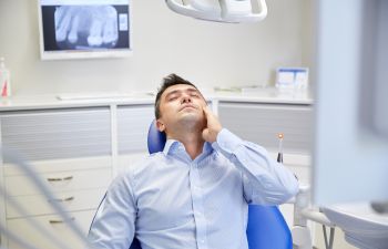 man with a toothache on the dentist chair Johns Creek, GA