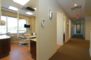 muccioli dental corridor with an dentist chair visible on the left