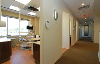 muccioli dental corridor with an dentist chair visible on the left