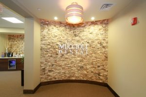 wall with muccioli dental logo