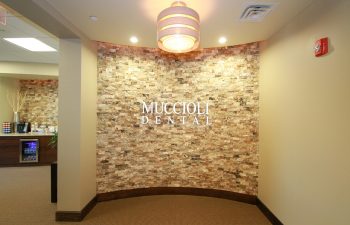 wall with muccioli dental logo