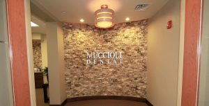 Muccioli Dental Logo on wall