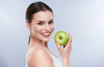 woman holding a green apple, 