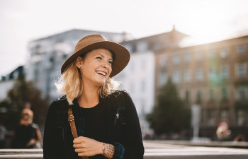 beautiful mature woman in hat laughs, 