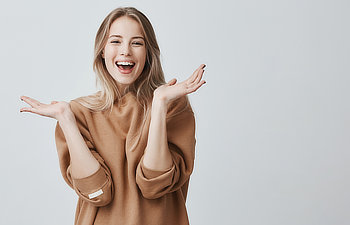 beautiful woman with blonde long hair looking at camera having excited and happy facial expression, 