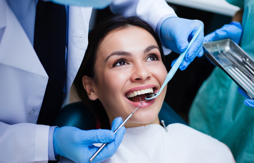 Perfect smile! Part of dentist examining his beautiful patient in dentist’s office, 