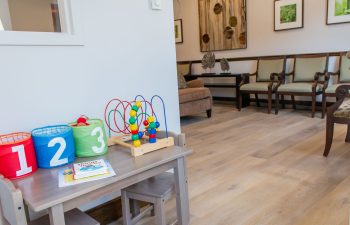 Children's play area with waiting room seating in background