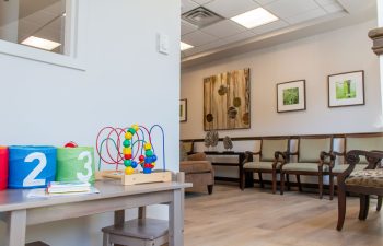 Kids activity table with wooden bead maze toy and picture books