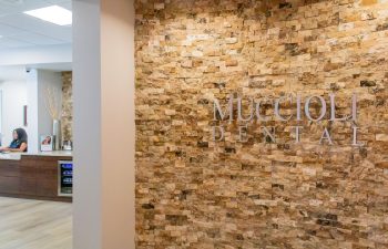 Muccioli Dental stone accent wall with reception desk in view