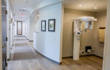 Hallway leading to treatment rooms with dental x-ray imaging equipment