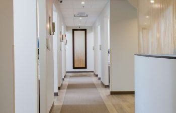 Dental office corridor lined with patient treatment room doors