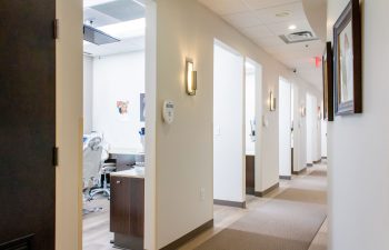 Hallway view into an open dental treatment room