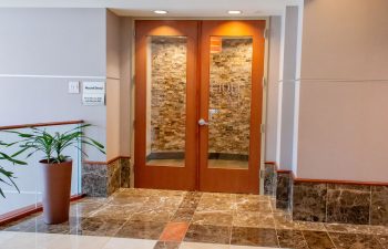 Office entrance with glass doors and stacked stone wall accent